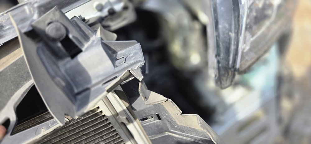 Damaged headlight mount and radiator support, repaired in Schenectady, NY