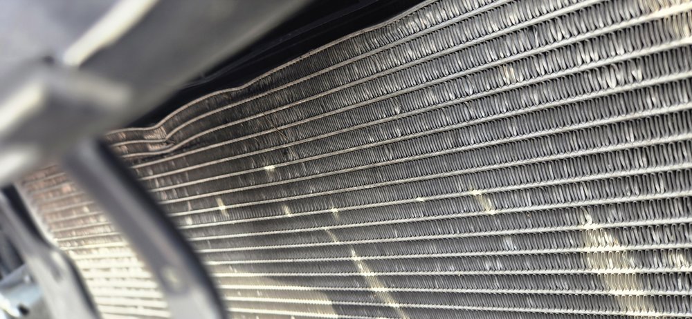 Damaged radiator behind the front bumper, repaired in Schenectady, NY